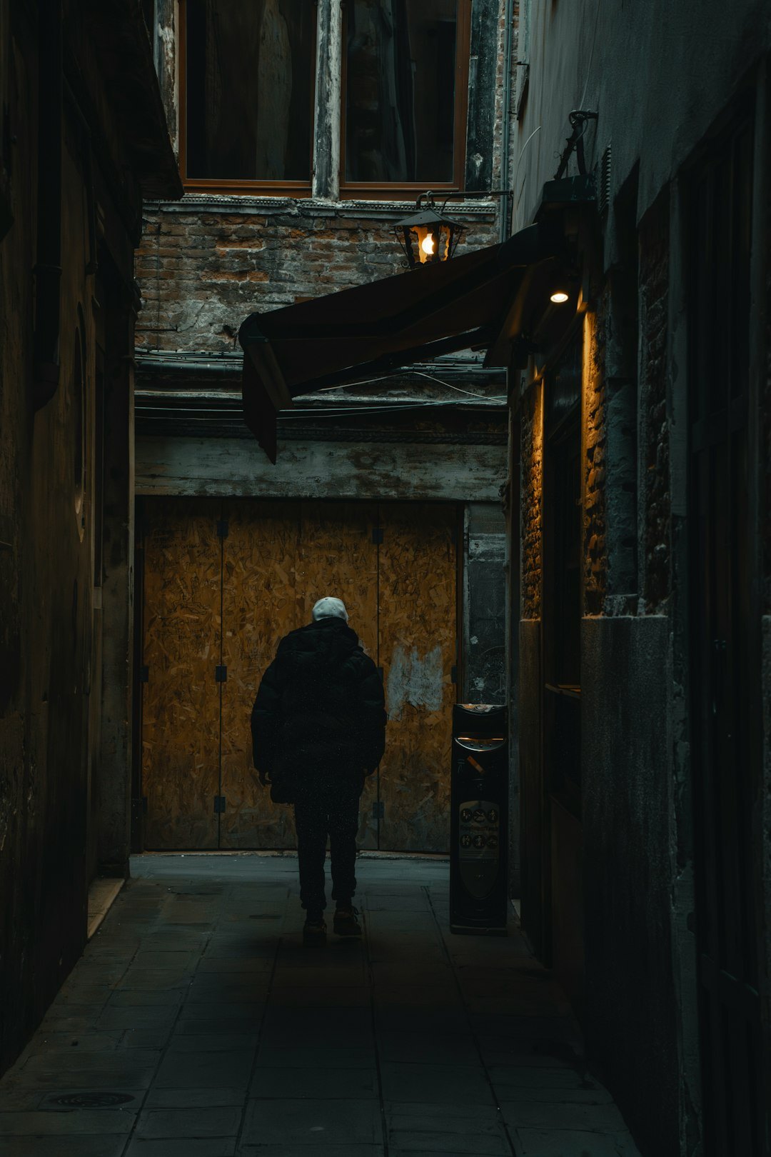 shadowy figure in dark alley